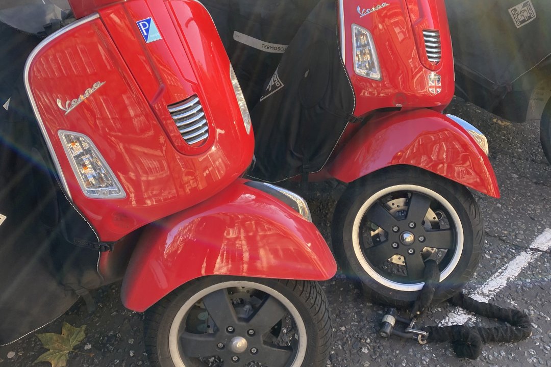 Two red Vespa GT300 scooters
