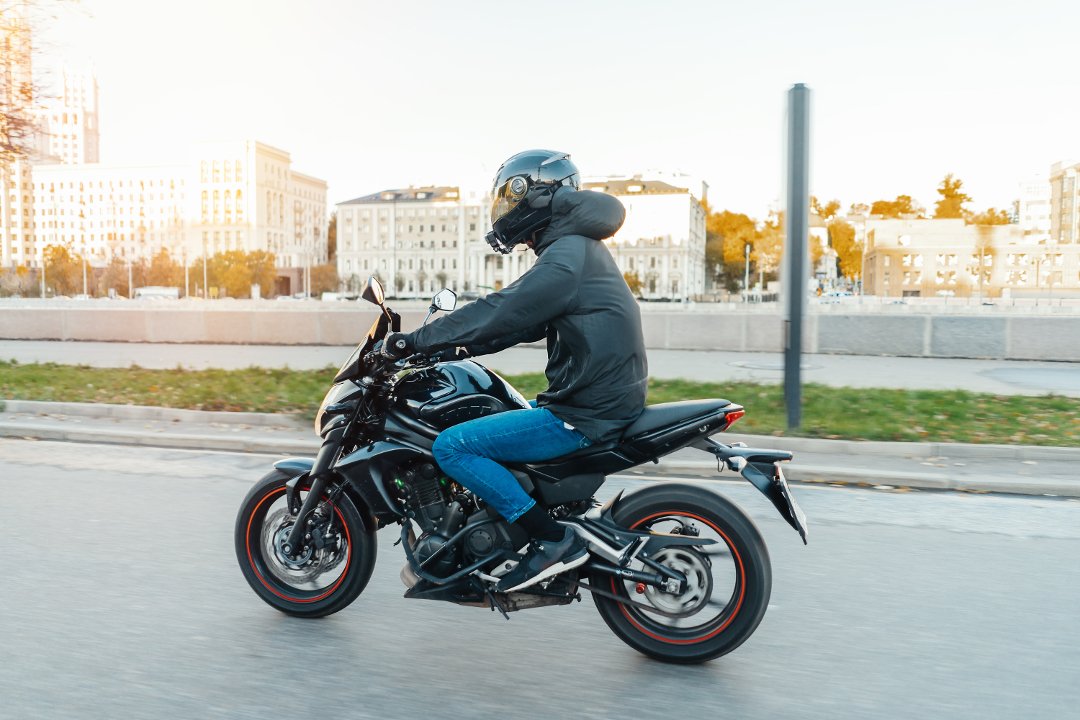 Man riding a black motorcycle