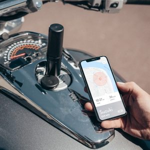 Monimoto tracker on the motorcycle and phone screen with opened app